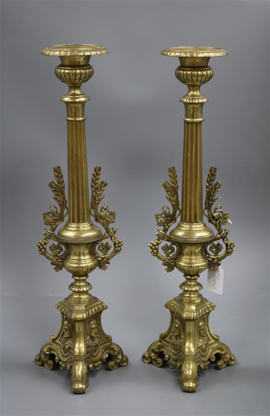 A pair of brass candlesticks 50cm high